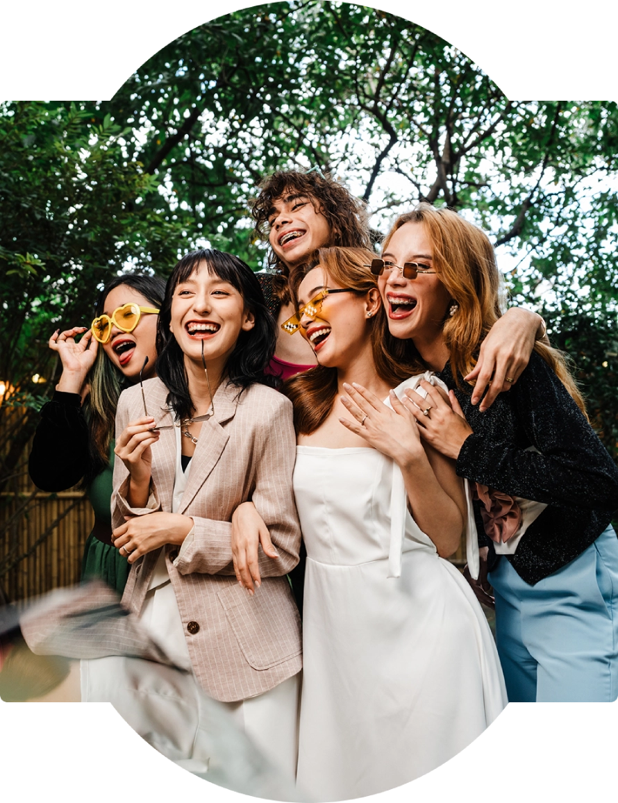 Group of friends laughing in a garden.