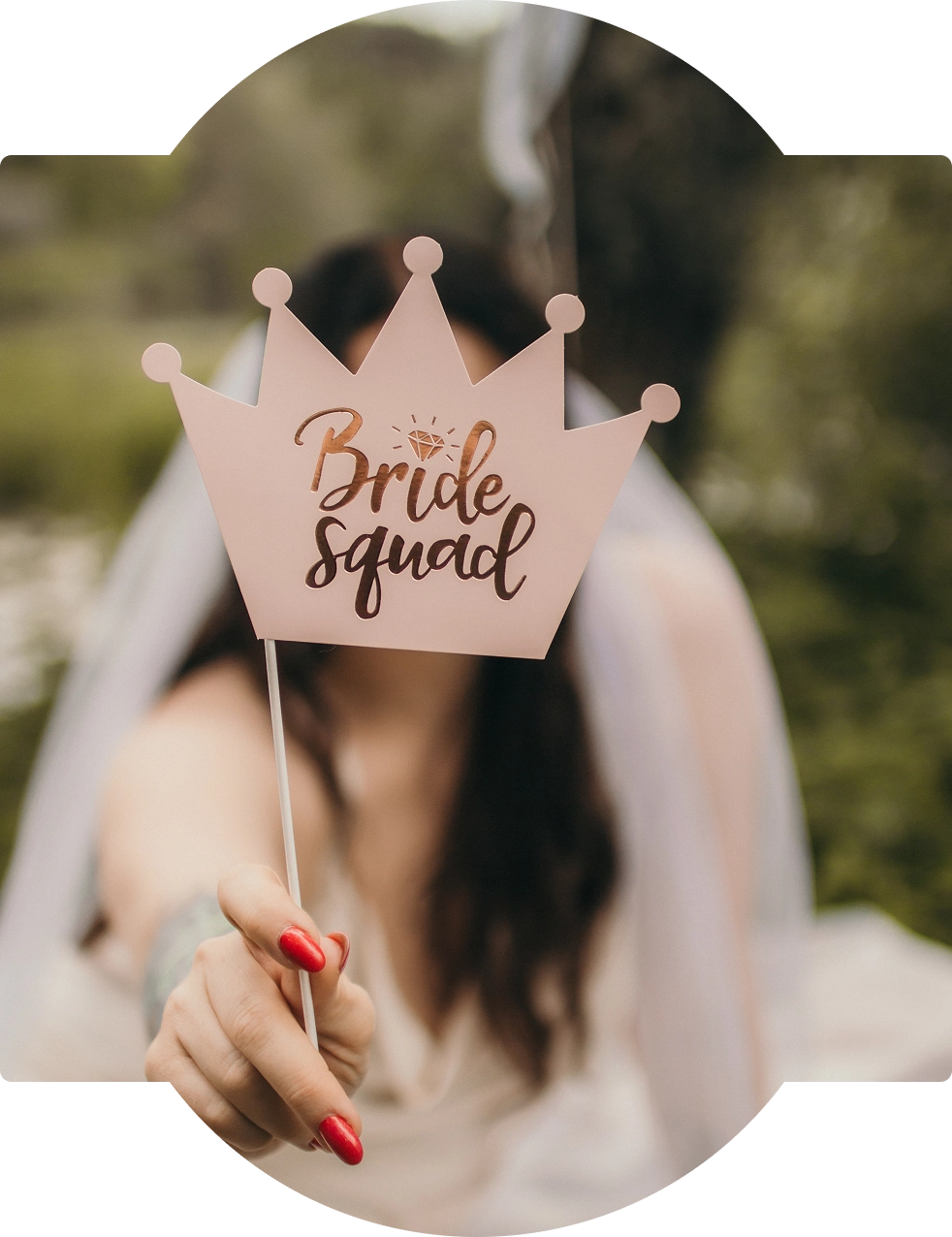Bride squad crown prop held by woman.